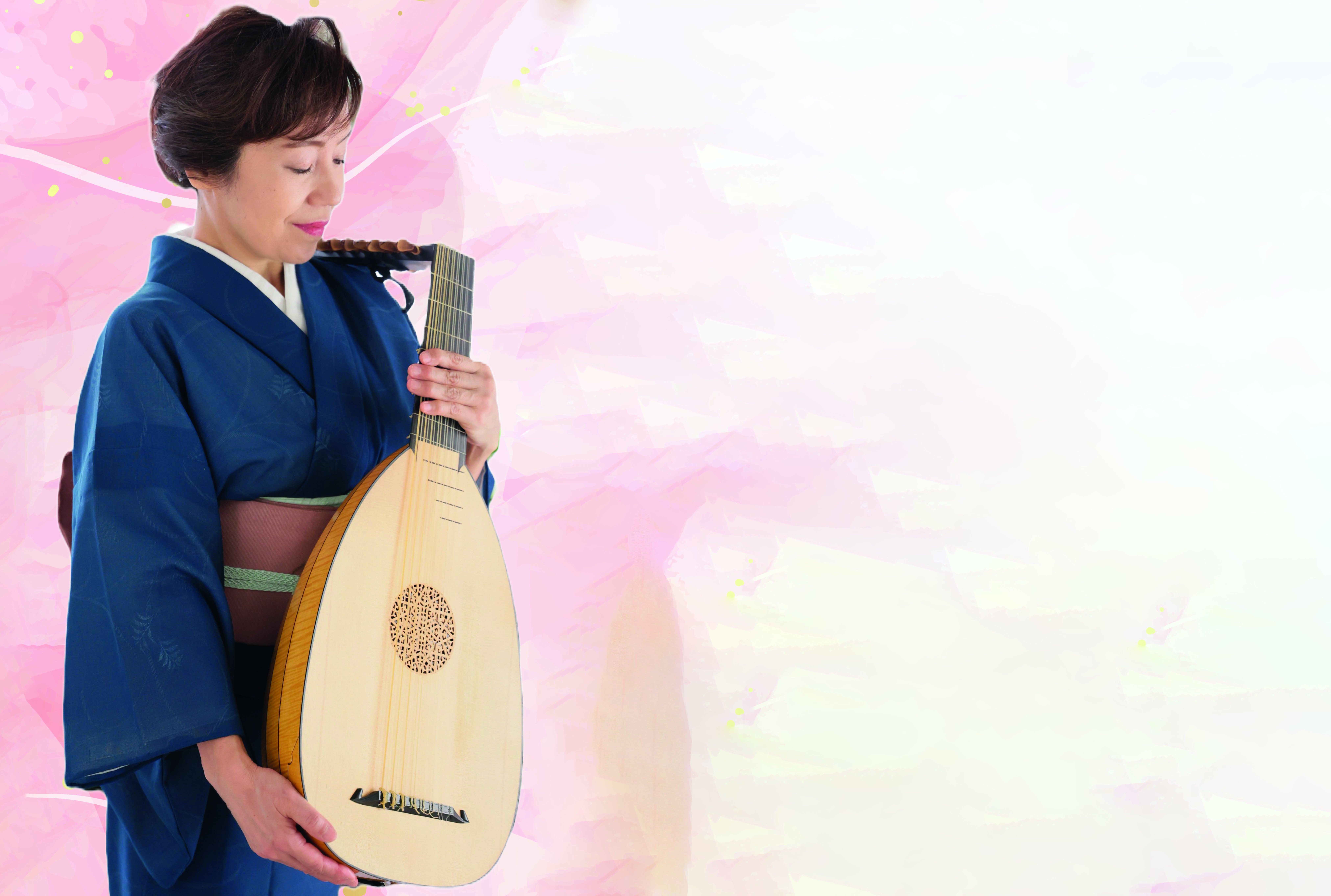 Mitsuko Watanabella on kädessään luuttu.